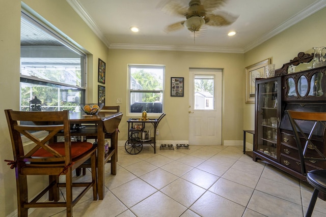 dining room featuring light tile patterned floors, baseboards, ornamental molding, and ceiling fan