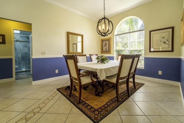 dining area with light tile patterned floors, a notable chandelier, baseboards, and ornamental molding