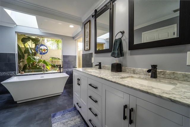 full bathroom with double vanity, tile walls, crown molding, and a sink