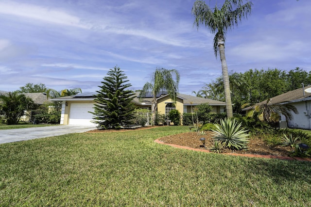 view of front of home featuring stucco siding, driveway, roof mounted solar panels, a front yard, and a garage