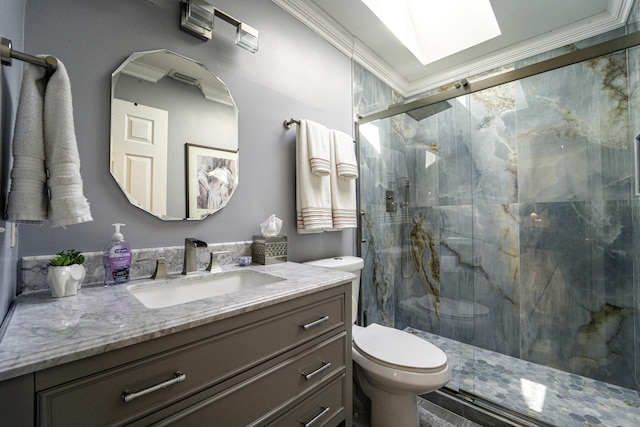 bathroom with vanity, a marble finish shower, a skylight, ornamental molding, and toilet