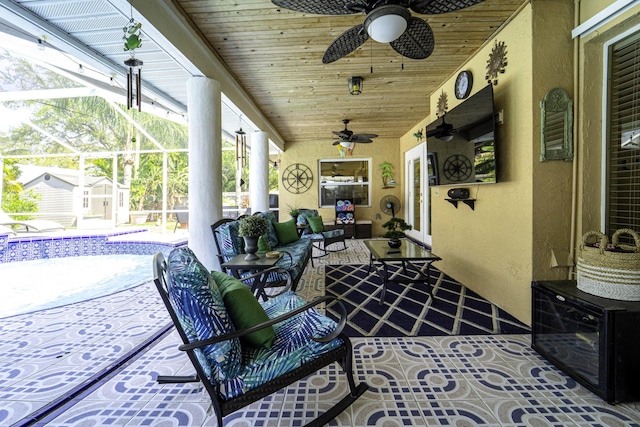 view of patio with ceiling fan, an outdoor pool, a lanai, and outdoor lounge area