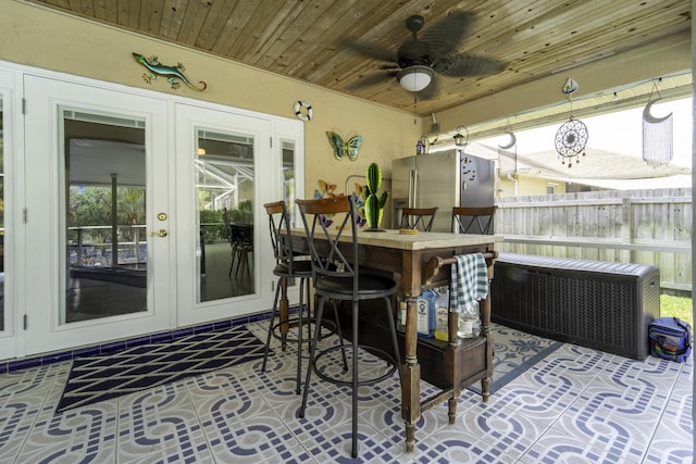 view of patio / terrace with french doors, ceiling fan, radiator heating unit, and fence