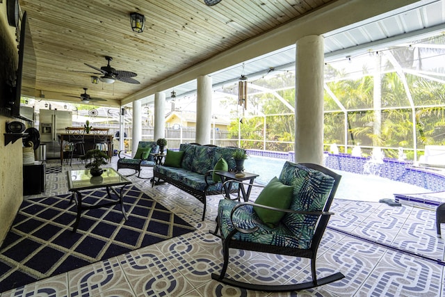 sunroom / solarium featuring a ceiling fan and wood ceiling