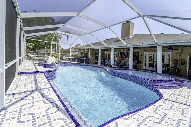 view of pool with a patio area, a lanai, a pool with connected hot tub, and ceiling fan