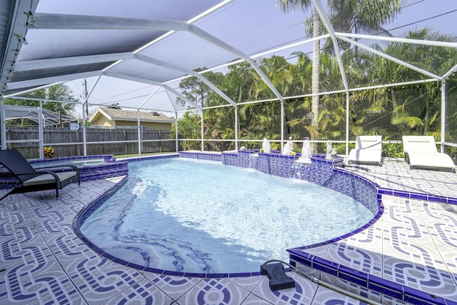 view of pool with fence, a fenced in pool, an in ground hot tub, a lanai, and a patio area