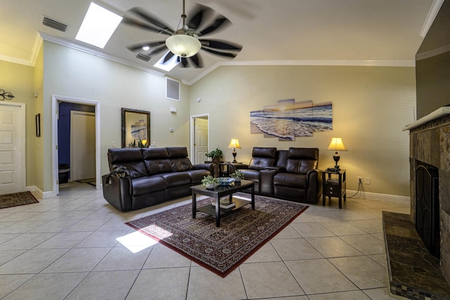 living room featuring visible vents, a fireplace with raised hearth, a ceiling fan, crown molding, and light tile patterned floors