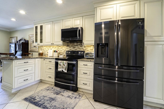 kitchen with a peninsula, dark stone counters, fridge with ice dispenser, and range with two ovens