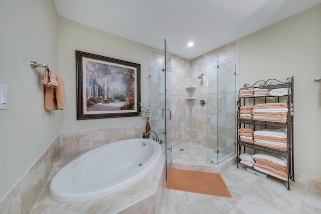 bathroom with a bath, tile patterned floors, recessed lighting, and a stall shower