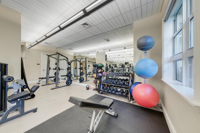 gym with baseboards and visible vents