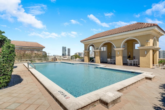 pool featuring a patio area and fence