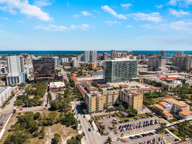 drone / aerial view featuring a view of city and a water view