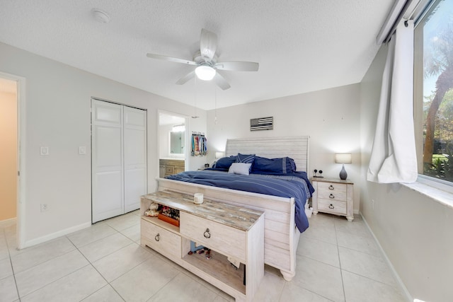 500 Scotia Dr Unit 106, Hypoluxo, FL 33462 - bedroom featuring a ceiling fan, a textured ceiling, a closet, light tile patterned floors, and baseboards