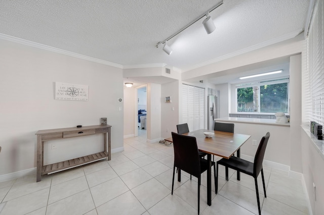 500 Scotia Dr Unit 106, Hypoluxo, FL 33462 - dining room with a textured ceiling, light tile patterned flooring, track lighting, ornamental molding, and visible vents