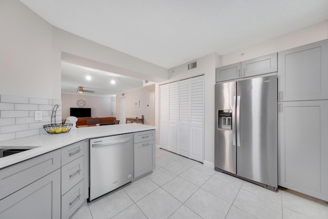 500 Scotia Dr Unit 106, Hypoluxo, FL 33462 - kitchen featuring stainless steel fridge, visible vents, dishwasher, gray cabinets, and light countertops