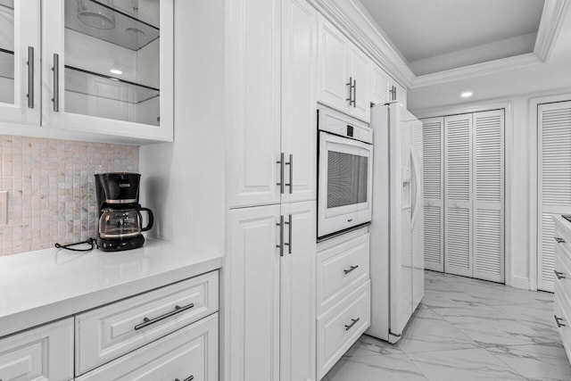 2000 S Ocean Blvd Unit 301, Delray Beach, FL 33483 - kitchen featuring white appliances, light countertops, white cabinets, glass insert cabinets, and marble finish floor