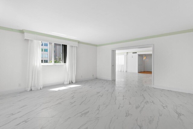 2000 S Ocean Blvd Unit 301, Delray Beach, FL 33483 - unfurnished room with plenty of natural light, baseboards, marble finish floor, and ornamental molding