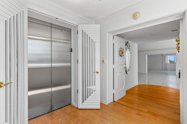 2000 S Ocean Blvd Unit 301, Delray Beach, FL 33483 - corridor with visible vents, a textured ceiling, crown molding, and wood finished floors