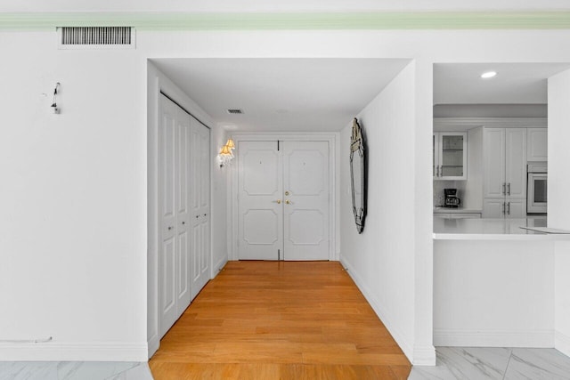 2000 S Ocean Blvd Unit 301, Delray Beach, FL 33483 - corridor featuring visible vents, light wood-style flooring, and baseboards