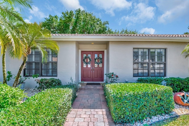 entrance to property featuring stucco siding