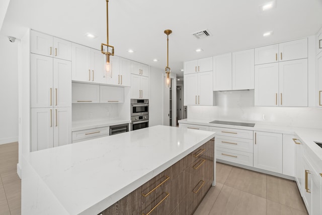 kitchen with visible vents, light tile patterned flooring, a large island, white cabinetry, and black electric stovetop