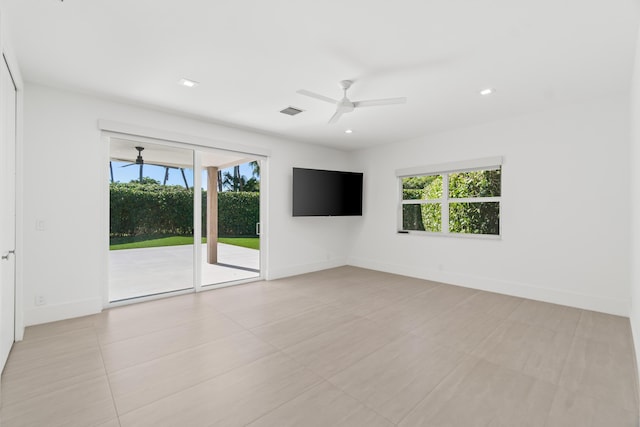 empty room featuring baseboards, a ceiling fan, visible vents, and a healthy amount of sunlight