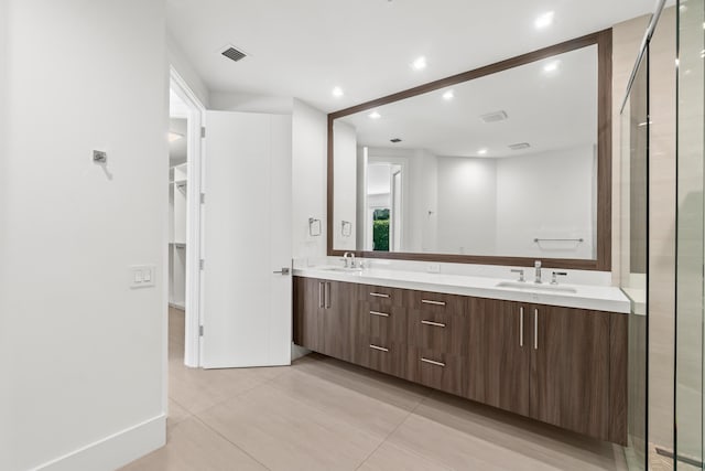 full bath featuring a sink, visible vents, recessed lighting, and double vanity