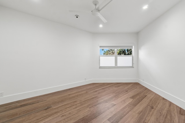 empty room with a ceiling fan, baseboards, and wood finished floors