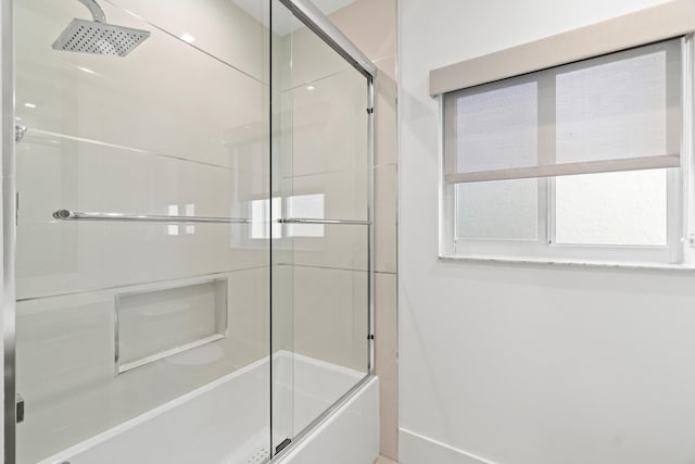 full bath featuring bath / shower combo with glass door