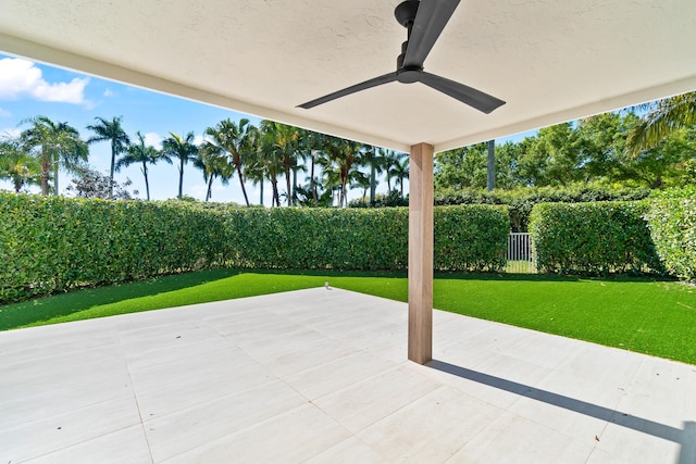 view of patio with a fenced backyard and a ceiling fan