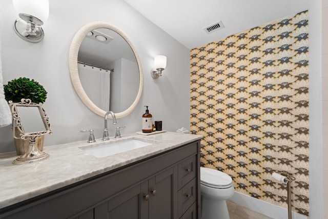 bathroom with tile patterned floors, visible vents, toilet, and vanity