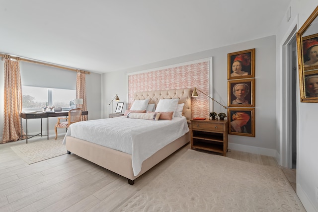 bedroom featuring light wood-style flooring and baseboards