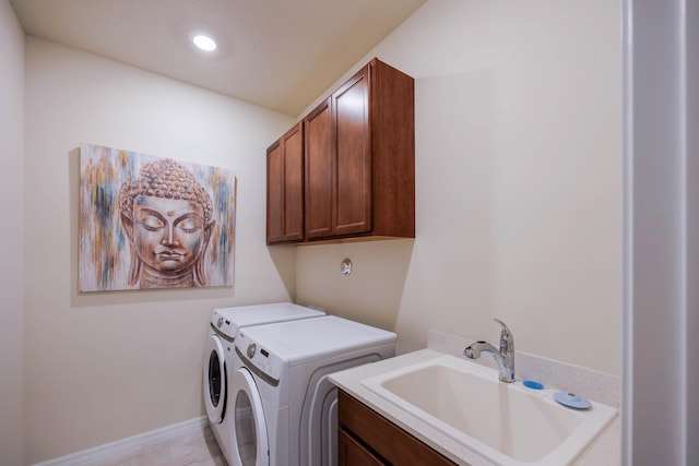 clothes washing area with a sink, cabinet space, recessed lighting, and washing machine and clothes dryer