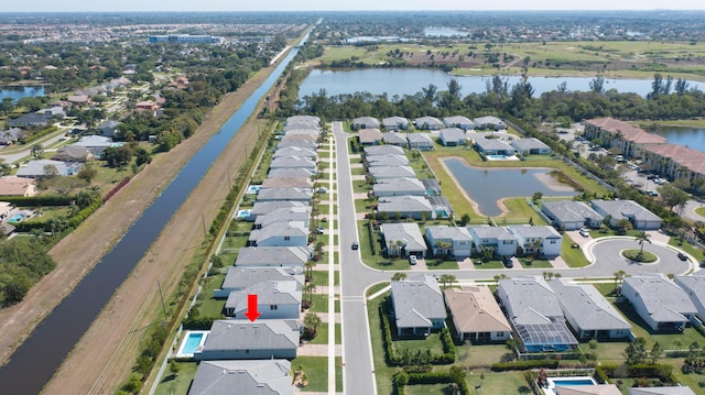 birds eye view of property with a residential view and a water view