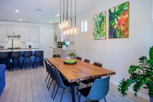 dining space featuring light wood-type flooring, visible vents, baseboards, and recessed lighting