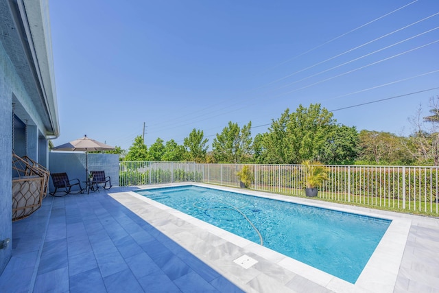 view of pool featuring a fenced in pool, a patio, and fence