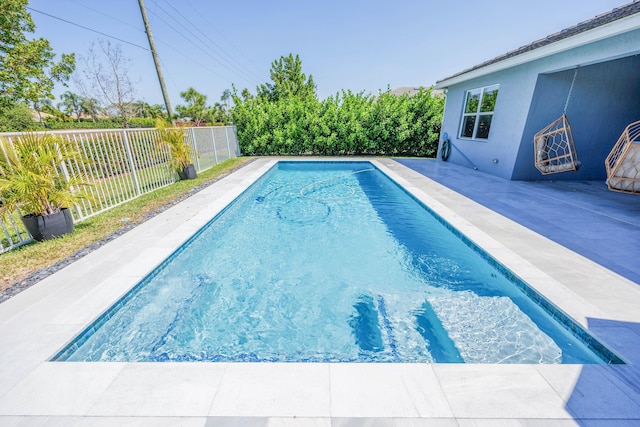 view of swimming pool featuring a fenced in pool, a patio area, and fence