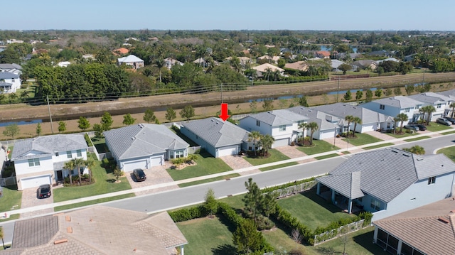 drone / aerial view with a residential view and a water view