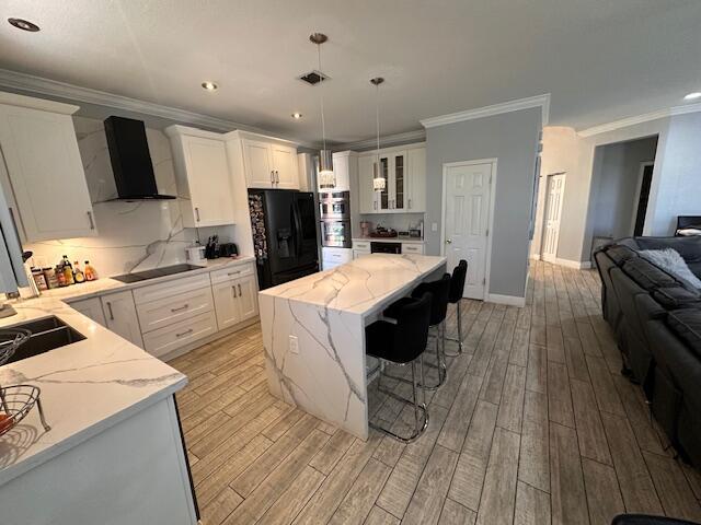 dining area featuring light wood finished floors, visible vents, a notable chandelier, and ornamental molding