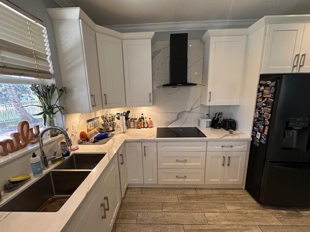 bar featuring beverage cooler, light wood-style flooring, double oven, and crown molding