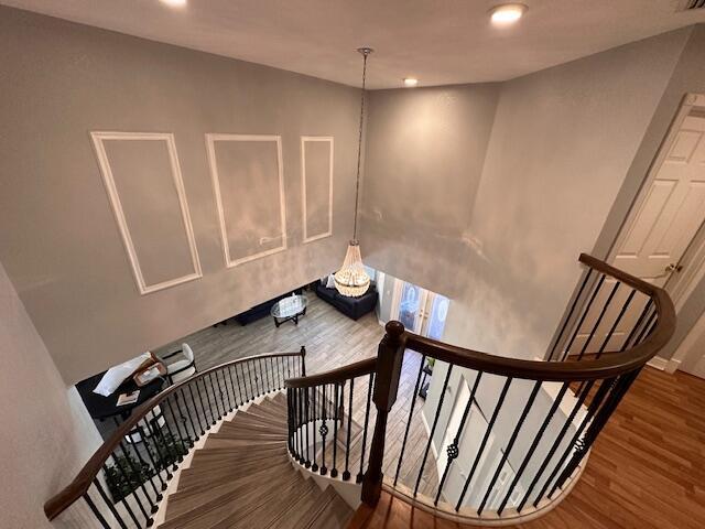 stairs featuring recessed lighting, wood finished floors, and baseboards