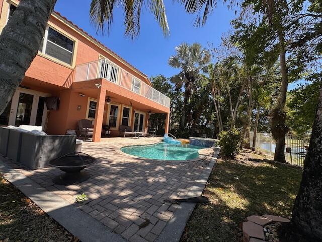 view of pool with a fenced in pool, a patio area, fence, and ceiling fan