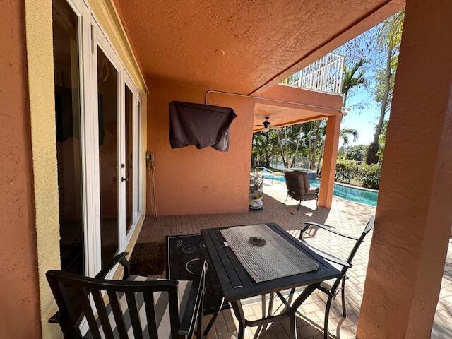 view of patio featuring outdoor dining space and an outdoor pool