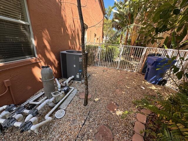 view of yard featuring cooling unit and fence