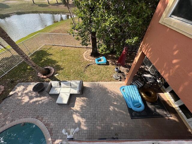 view of patio featuring a fenced backyard and a water view