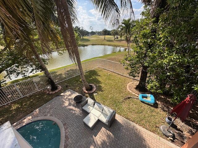 view of patio / terrace with a fenced backyard and a water view