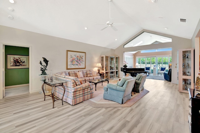 living area with visible vents, baseboards, a ceiling fan, and light wood finished floors