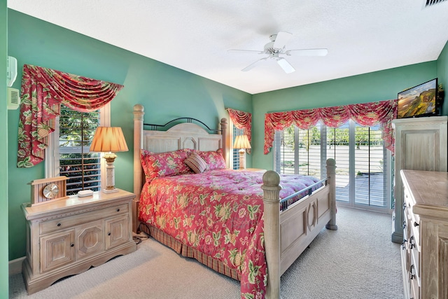 bedroom featuring access to exterior, visible vents, light colored carpet, and a ceiling fan