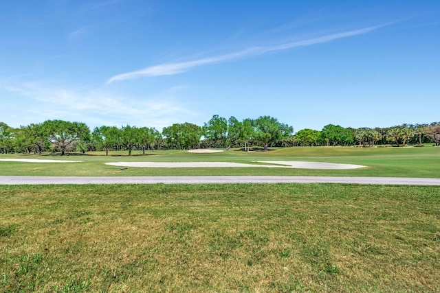 view of community featuring a lawn and golf course view