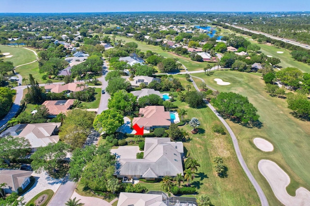 drone / aerial view with a residential view and golf course view